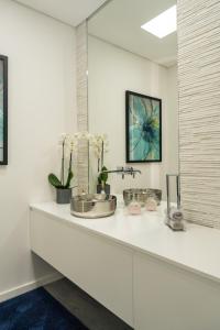 a bathroom counter with a sink and a mirror at Vietnam house in Areias de Vilar