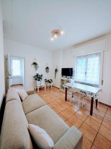 a living room with a couch and a table at Foce24 - City Garden - in Imperia
