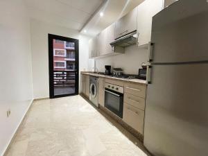 a kitchen with a refrigerator and a washer at luxury Aprt2 bedrooms Pool hivernage heart of city in Marrakech
