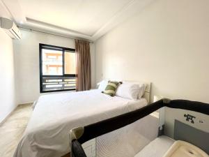 a bedroom with a white bed and a window at luxury Aprt2 bedrooms Pool hivernage heart of city in Marrakech +17 photos