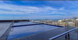 a swimming pool on the roof of a building at Delft Apartemen CPI in Tanjungbunga