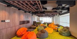 a room with a bunch of bean bags on the floor at Delft Apartemen CPI in Tanjungbunga