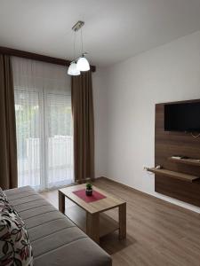 a living room with a couch and a table at Apartmants S&H in Ulcinj
