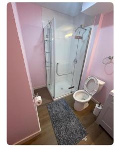 a bathroom with a toilet and a glass shower at Bedroom in Upland D in Edmonton