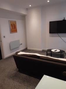 a room with a flat screen tv on a wall at Three bedroom apartment Darlington Victoria Road in Darlington +11 photos
