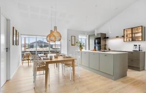 a kitchen and dining room with a table and chairs at 3 Bedroom Lovely Home In Løkken in Løkken