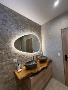 a bathroom with two sinks and a mirror at La Maison Myrtille in Castellane +15 photos