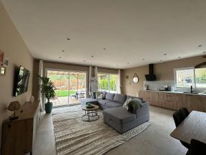 a living room with a couch and a kitchen at La Maison Myrtille in Castellane