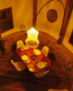 a table with chairs and a lamp in a room at La Richard Refugio Boutique in Dique Nivelador