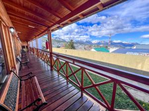 a balcony with benches and a view of a city at Choconcito Apart Hotel in Ushuaia
