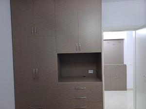 a closet with wooden cabinets in a room at 3 rooms apartment in vlora in Vlorë