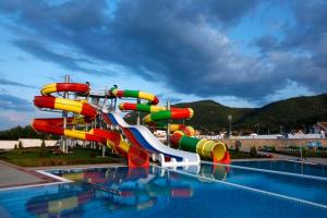 a colorful water slide in a swimming pool at COMODO "Green Hill" in Soko Banja