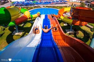 a group of people riding a water slide at a water park at COMODO "Green Hill" in Soko Banja