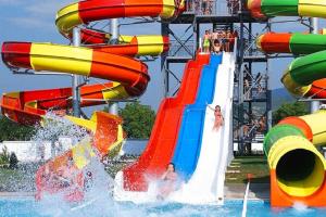a water slide at a water park with people on it at COMODO "Green Hill" in Soko Banja