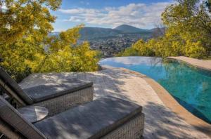 a swimming pool with a view of the mountains at Luxury Modern Provencal Villa Infinity Pool Epic Seaview near Cannes Festival-Ready in Mandelieu-la-Napoule
