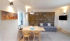 a living room with a table and a couch at Marmaras Mani Houses in Riglia