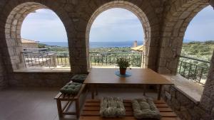 a room with a table and a view of the ocean at Marmaras Mani Houses in Riglia