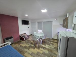 a room with a table and chairs and a kitchen at Sur Bonito in Río Grande