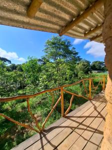 a wooden porch with a view of the trees at Chalé Ecológico na Natureza in Piedade