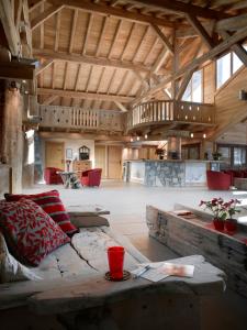 a large living room with a couch and a table at CGH Résidences & Spas Le Village De Lessy in Le Grand-Bornand
