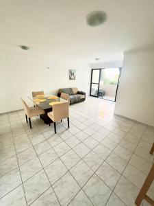a living room with a table and a couch at Beach Mar de Gênova 202- Espaço & Conforto Praia Bessa in João Pessoa