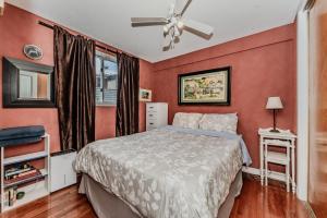 a bedroom with a bed and a ceiling fan at The Louise - Artistic Haven by the Beach in Wiarton