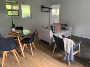 a living room with a table and chairs and a couch at Clarendon Country Cottage private retreat in Clarendon +20 photos