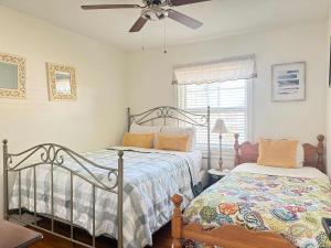 a bedroom with two beds and a ceiling fan at RF Central location w fenced backyard FIRE-PIT in Richmond