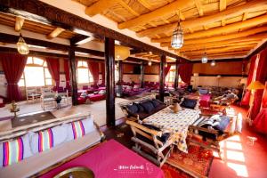 a large room with tables and chairs in a building at Kasbah ben Ali in El Kelaa des Mgouna