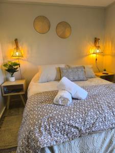 a bedroom with a bed with two lamps on the wall at Coyhaique, CASA LAVANDA in Coihaique