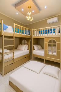 a kids room with bunk beds and a chandelier at Discover Tranquility by the Sea at Porto Said Resort in Port Said
