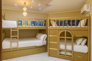 two bunk beds in a childs room at Discover Tranquility by the Sea at Porto Said Resort in Port Said +46 photos