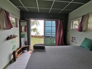 a bedroom with a large bed and a large window at kohchang7seaview Bungalows in Ban Bang Bao