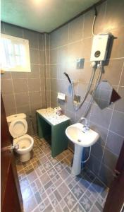 a bathroom with a toilet and a sink at kohchang7seaview Bungalows in Ban Bang Bao