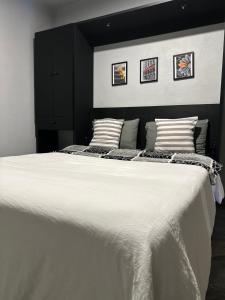 a bedroom with a large white bed with two pillows at Santa Noche Suite & Spa in San Miguel de Allende
