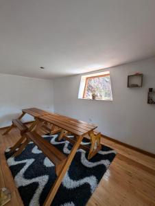 a room with a wooden table and a window at Paullo Lodge in Coya