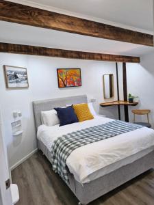 a bedroom with a large bed in a room at The Bullock & Bridle Retreat at 58 in Mintaro