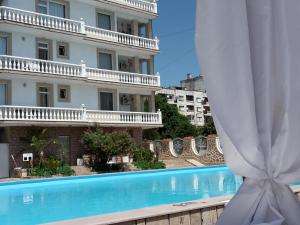 a view of the hotel from the swimming pool at Family Hotel Zhelkovi - Olympia in Kharmanli