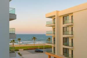 an apartment building with a view of the ocean at Luxurious Chalet in Port Said Governorate with Breathtaking View in Port Said