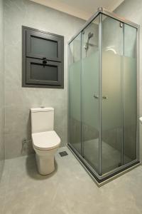 a bathroom with a toilet and a glass shower at Luxurious Chalet in Port Said Governorate with Breathtaking View in Port Said +40 photos