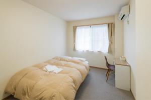 Postel nebo postele na pokoji v ubytování Hotel Morimotoya 板野店