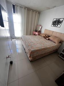 a bedroom with a bed with a dog laying on it at Apartamento centro garanhuns 3 quartos in Garanhuns