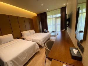 Postel nebo postele na pokoji v ubytování Uiwang Milos Hotel