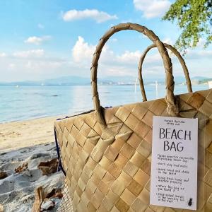 a beach bag sitting on the beach with a sign on it at UMI Nest Apartment in Subic Bay with Self-Serve Breakfast - WiFi, Bathtub, Barbecue, Pet Friendly with a Fee in Santa Rita