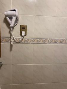a phone on a wall in a bathroom at CHALET CHAPITAL Punta Arenas in Punta Arenas