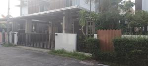 a white refrigerator in front of a house at Harmony Heaven in Ban Yep Chaeng