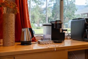 a coffee maker sitting on a counter next to a microwave at Pool-GameRoom-HomeTheater-Bar-PlayStructure-FirePit in Oakhurst