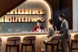 a man and a woman sitting at a bar at ANA InterContinental Tokyo by IHG in Tokyo