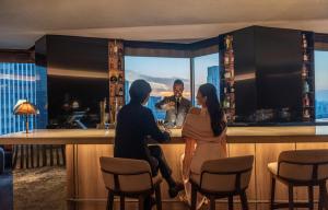 a man and a woman sitting at a bar at ANA InterContinental Tokyo by IHG in Tokyo