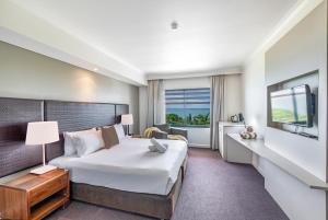 Ένα ή περισσότερα κρεβάτια σε δωμάτιο στο 'Top Horizons' Resort style Stay with Pool & Ocean Views